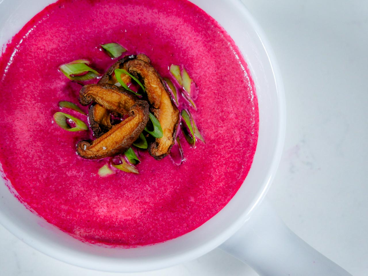 Beet soup in white bowl