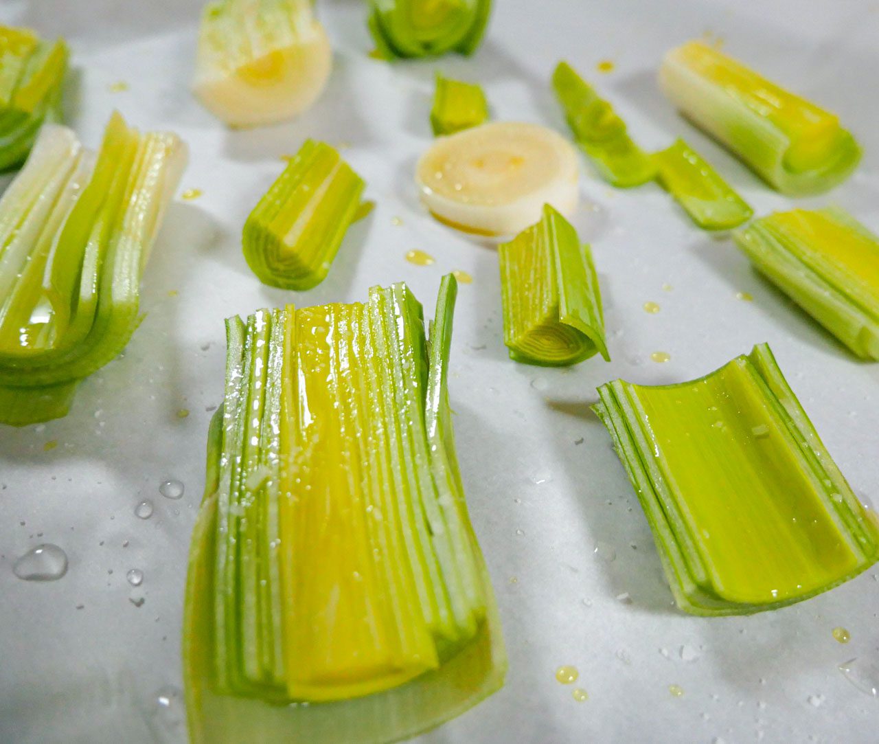 Uncooked leeks on a baking sheet