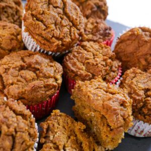 Tiger nut pumpkin muffins stacked on the counter