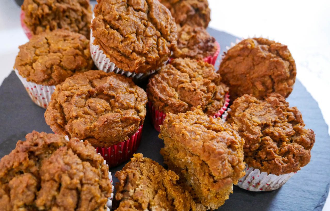 Tiger nut pumpkin muffins stacked on the counter