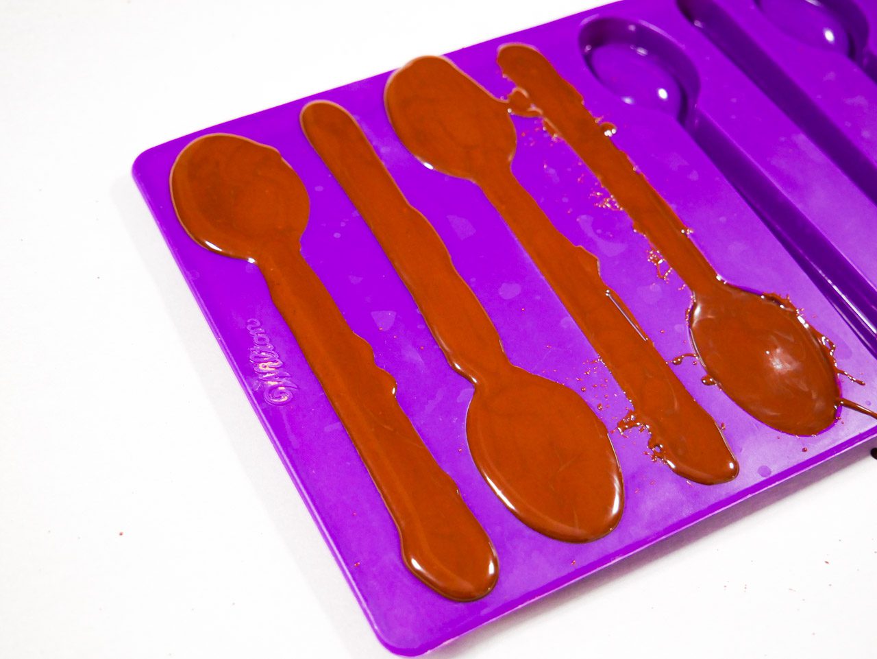 Piped in chocolate in spoon molds 