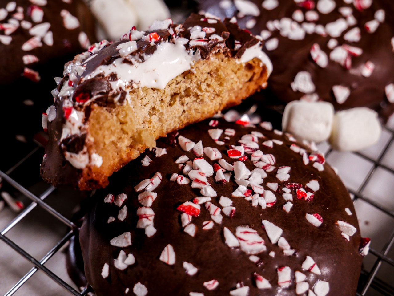 Peppermint Chocolate Marshmallow cookies on a wire rack bitten