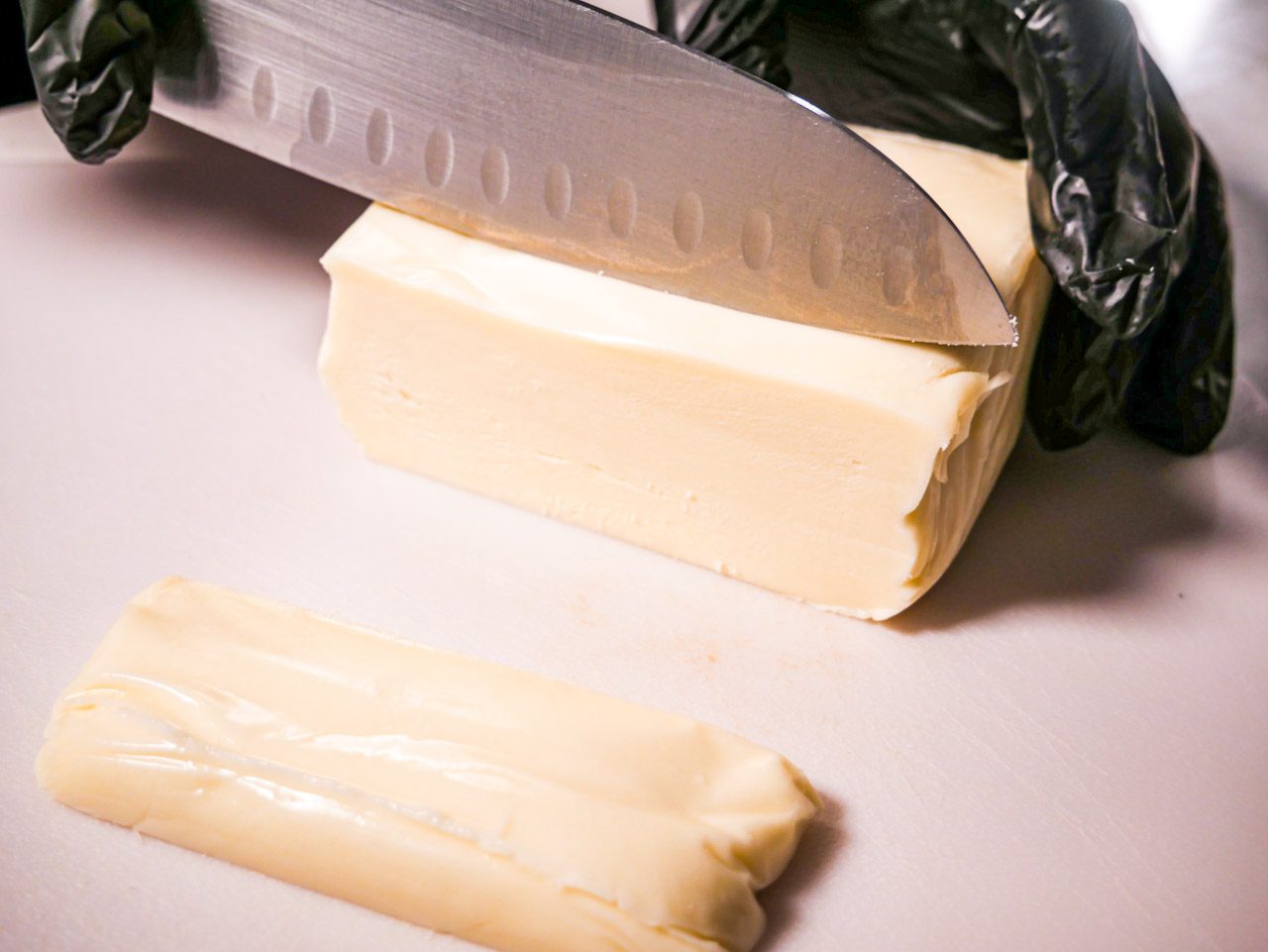 Sliced Mozzarella on a white cutting board