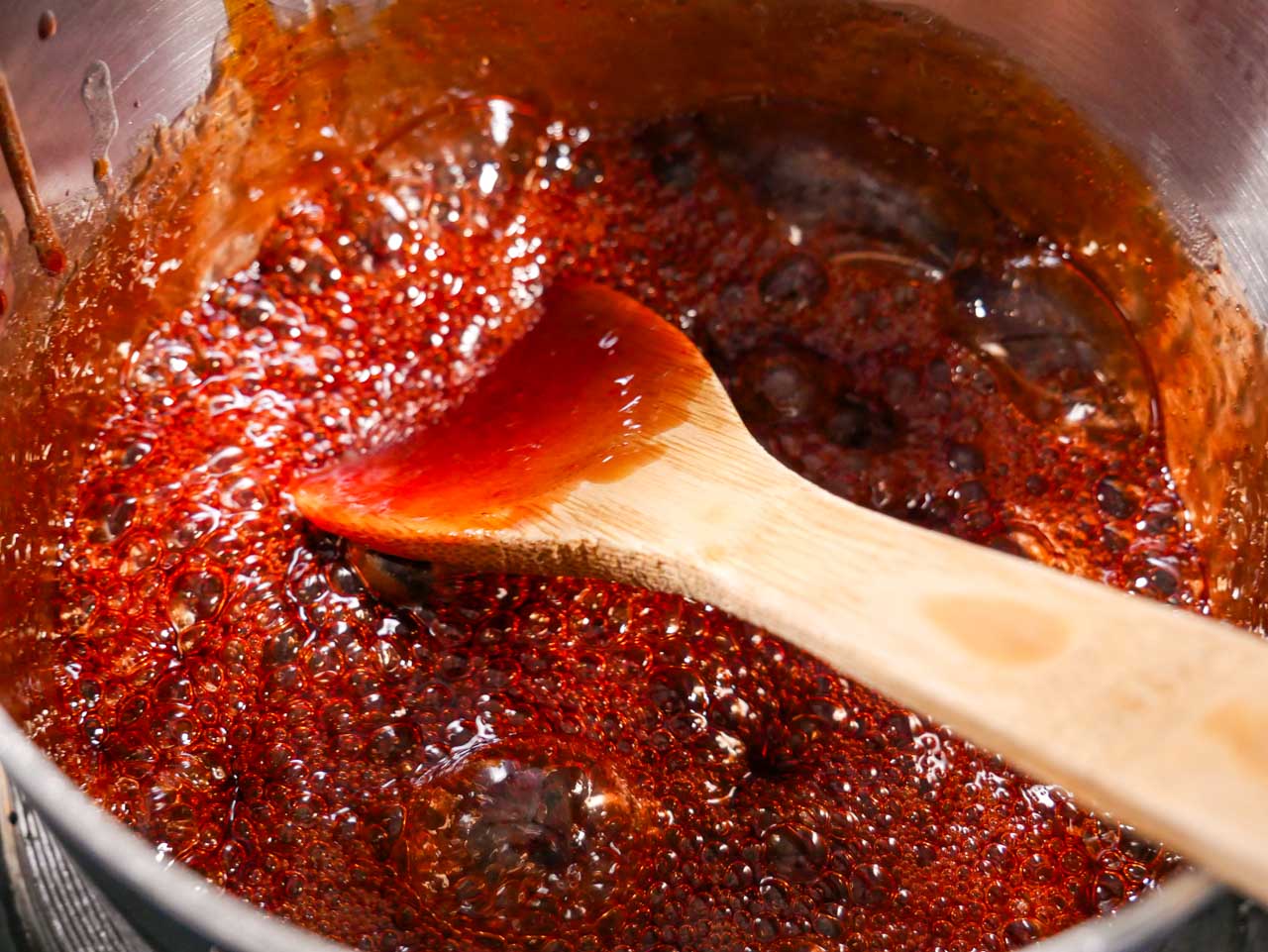 Sweet Sriracha sauce reducing in pot