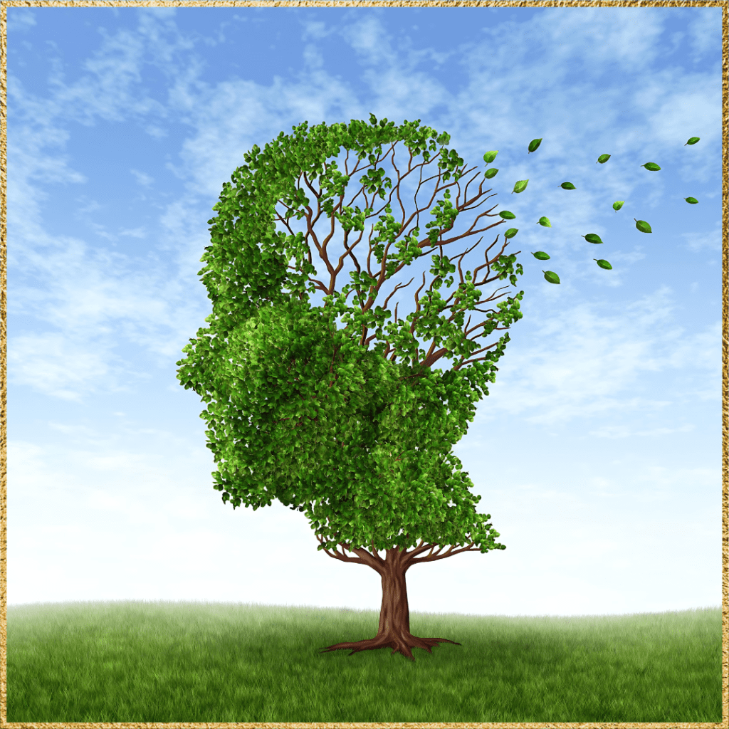 A tree with branches and leaves shaped like a human head to represent signs of repressed childhood trauma in adults. Some of the branches are exposed and leaves are floating away in the cloudy blue sky. Green grass lies beneath the tree.