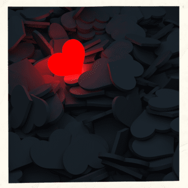 Embracing Your 'Too Much' - Red glowing heart in the darkness among other hearts