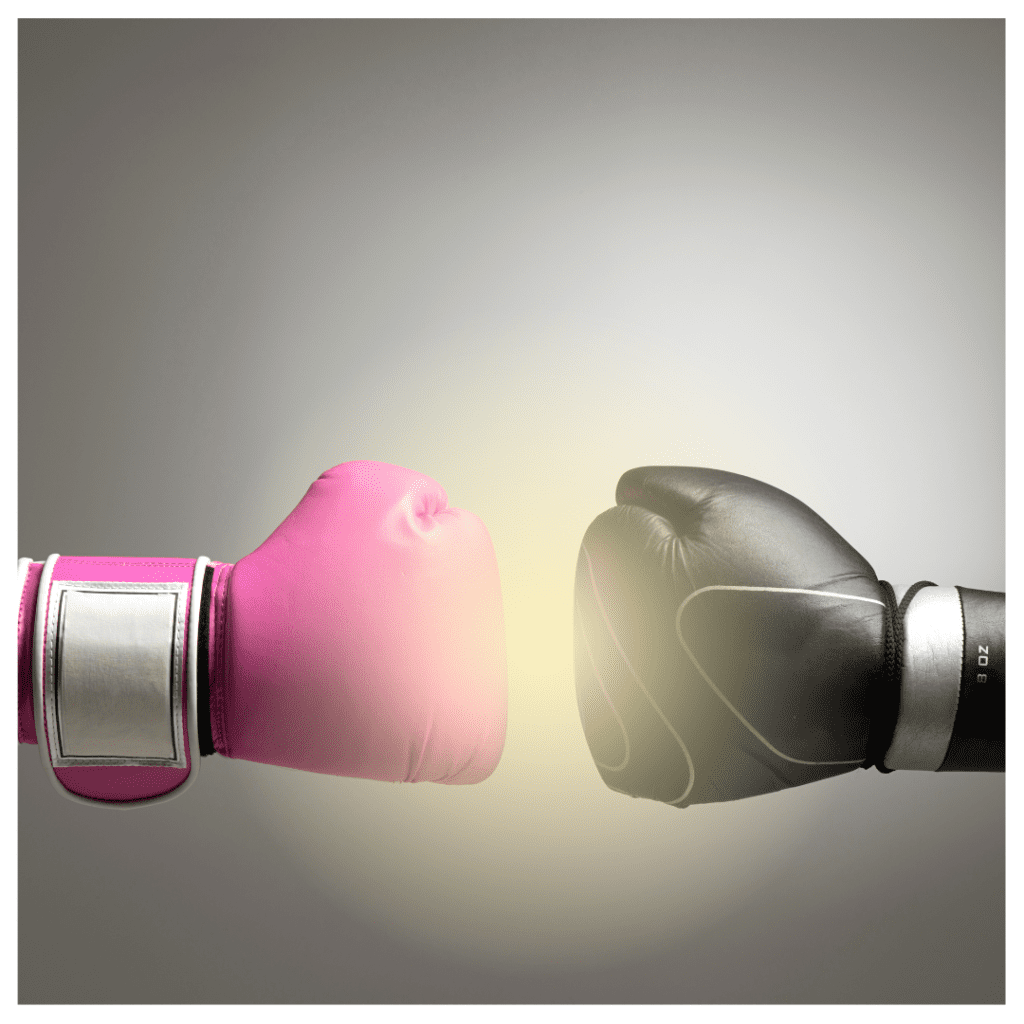 Balancing masculine and feminine energy. Two boxing globes against a gray background with a glowing light between them. One is black and the other is pink. 