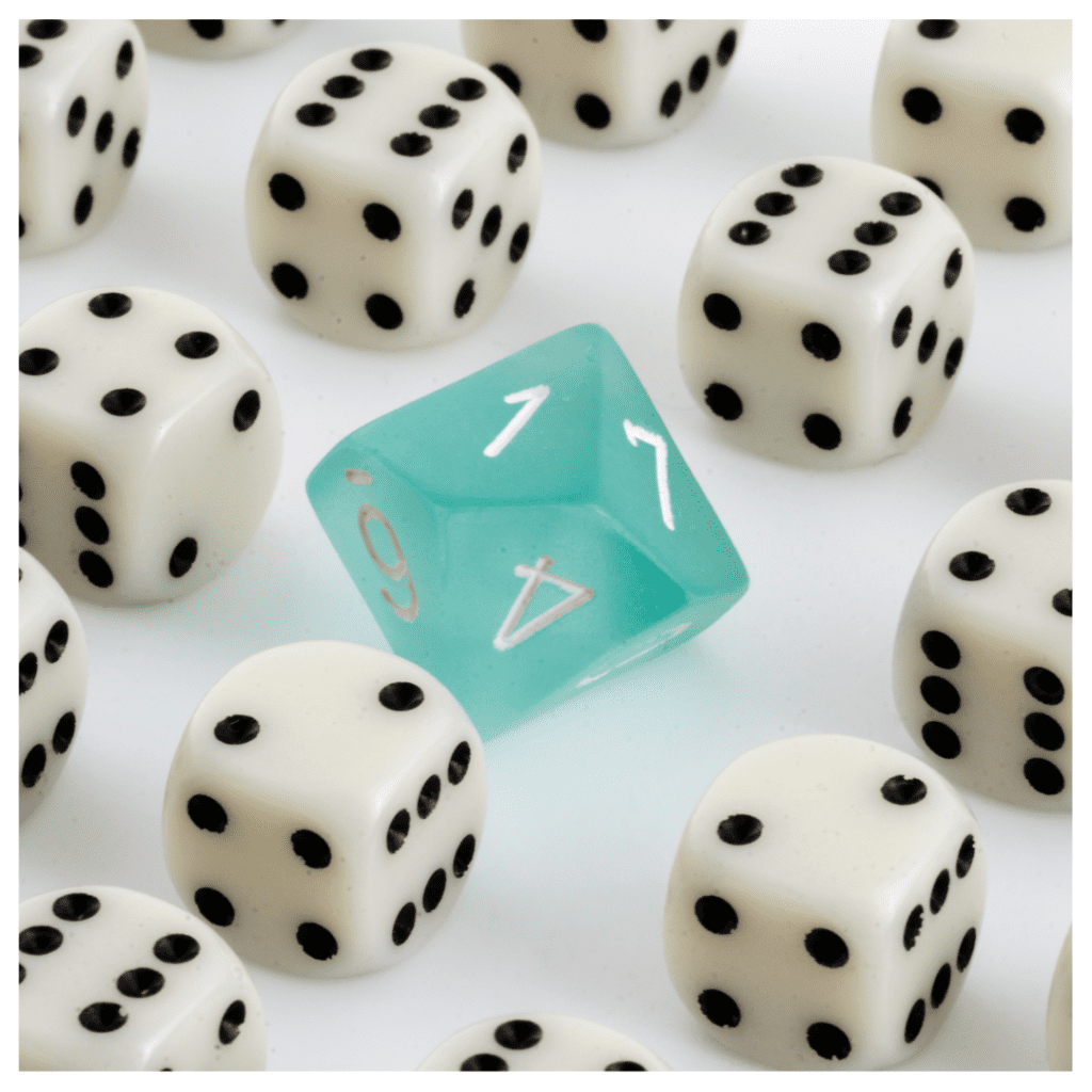 A light blue dungeons and dragons dice in the middle of regular die against a white background. Represents deviations from social norms.