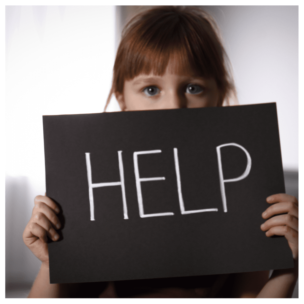 4 types of emotionally immature parents - a child holding up a black piece of paper that cover her mouth and body. It reads "Help" in white letters. She stands against a white background