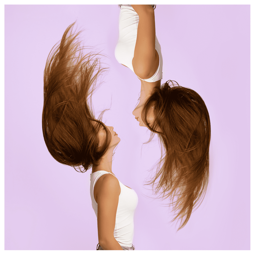 A women flipping her hair up and back. The same image is flipped and turned upside down to signify emotional reactivity.